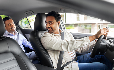 Image showing middle aged male passenger talking to car driver