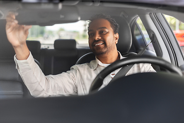 Image showing smiling indian man or driver driving car