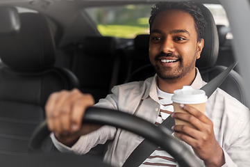 Image showing happy indian man or driver with coffee driving car