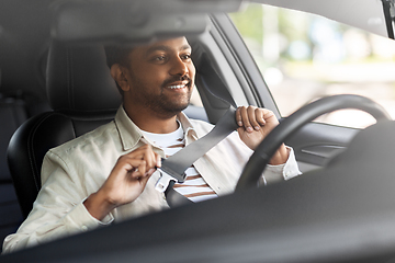 Image showing smiling indian man or driver driving car