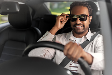 Image showing smiling indian man in sunglasses driving car