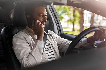 Image showing indian man driving car and calling on smartphone