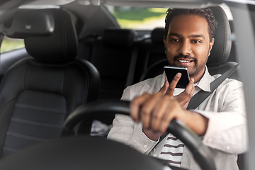 Image showing man driving car and recording voice by smartphone