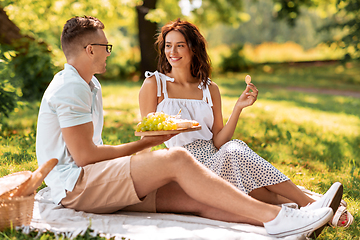 Image showing happy couple having picnic at summer park