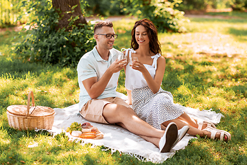 Image showing happy couple having picnic at summer park