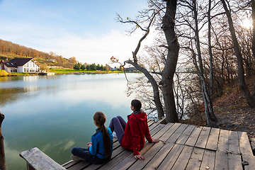 Image showing Girl and girl enjoy the view near the mountain lake