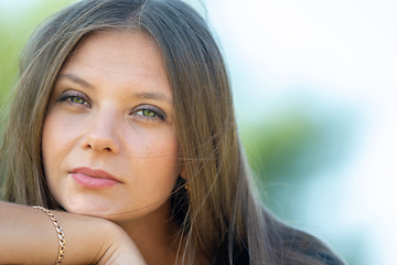 Image showing Close-up portrait of a beautiful girl of Slavic appearance, the girl squints into the frame