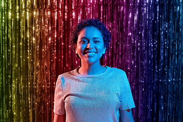 Image showing african woman at party over rainbow curtain