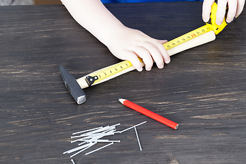 Image showing hands with a ruler checking