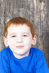 Image showing cunning look of a red-haired boy