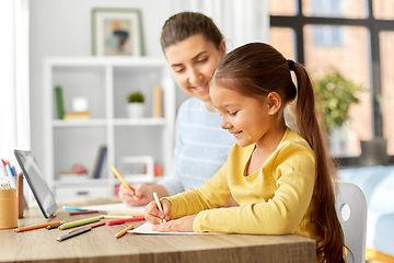 Image showing mother with little daughter drawing at home