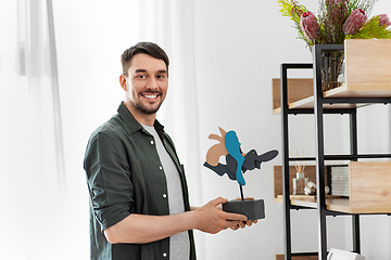 Image showing man decorating home with art in frame