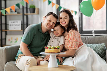 Image showing happy family with birthday cake hugging at home