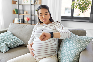 Image showing pregnant woman having labor contractions at home