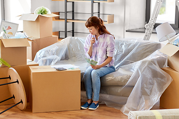 Image showing asian woman moving to new home and counting money