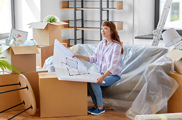 Image showing woman with blueprint and boxes moving to new home