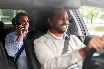 Image showing male passenger calling on smartphone in taxi car