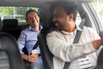 Image showing male passenger with coffee talking to car driver