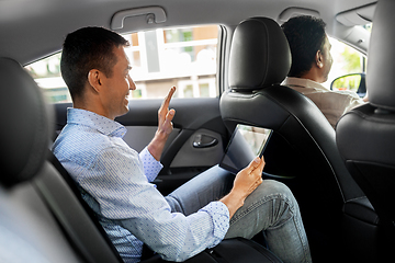 Image showing man with tablet pc having video call in taxi car