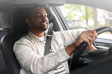 Image showing smiling indian man or driver driving car