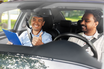 Image showing smiling car driving school instructor and driver