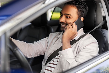 Image showing indian man driving car and calling on smartphone