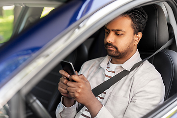 Image showing indian man in car using smartphone