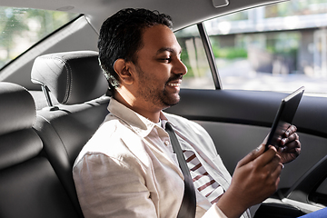 Image showing indian male passenger with tablet pc in taxi car