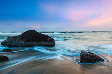 Image showing waves and rocks on beach of sunset