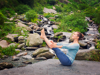 Image showing Woman doing Ashtanga Vinyasa Yoga asana Navasana - boat pose