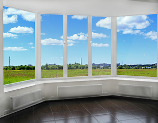 Image showing window to the summer field and view of tubes of city