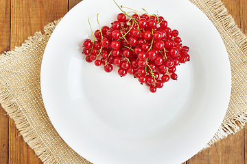 Image showing Berries of a red currant on the white plate