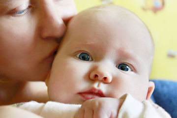 Image showing mother kisses her little daughter