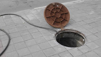 Image showing Close up of metal cover over concrete manhole at construction site