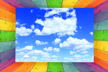 Image showing multicilored frame on the cloudy blue sky background