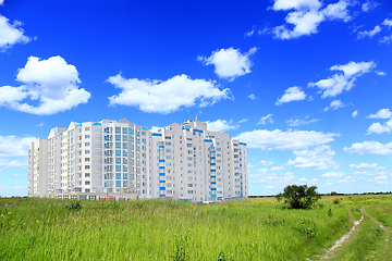Image showing multistory modern blocks of flat in field with grass