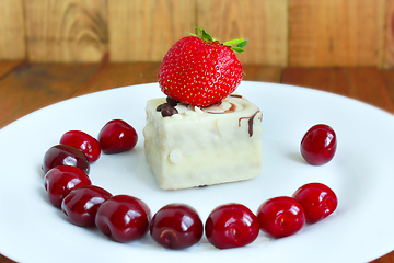 Image showing strawberry and cherries on the white plate with cake