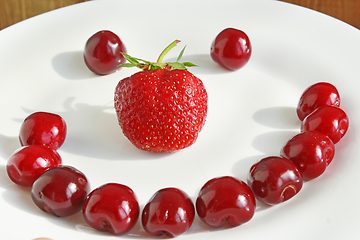 Image showing strawberry cherry with cake in shape of smile