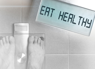 Image showing Man\'s feet on weight scale - Eat healthy