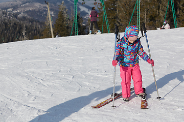 Image showing A happy little girl off skiing with slides