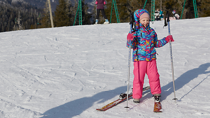 Image showing A happy little girl off skiing with slides