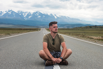 Image showing Man sitting on the road