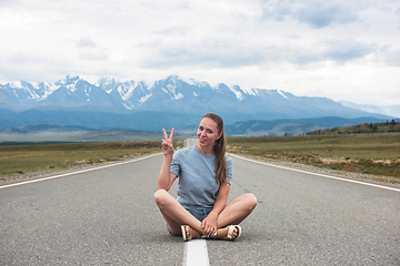 Image showing Woman sitting on the road