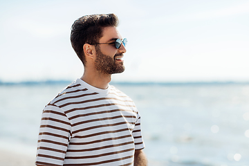 Image showing smiling young man in sunglasses on summer beach