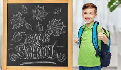 Image showing happy student boy with school bag over chalkboard