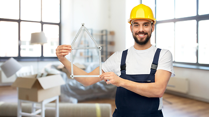 Image showing happy male builder with carpenter's rule at home