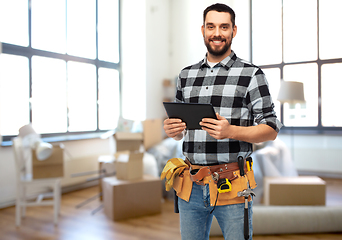 Image showing happy builder with tablet pc and tools at home