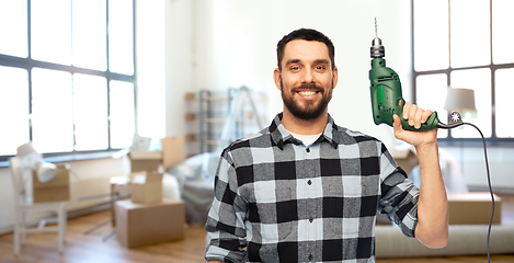 Image showing happy man, worker or builder with drill at home