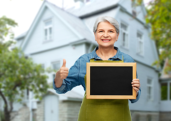 Image showing senior gardener with chalkboard showing thumbs up