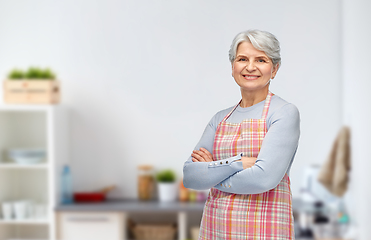 Image showing portrait of smiling senior woman in kitchen apron